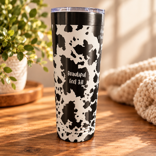Close-up of cow print tumbler design and scripture engraving