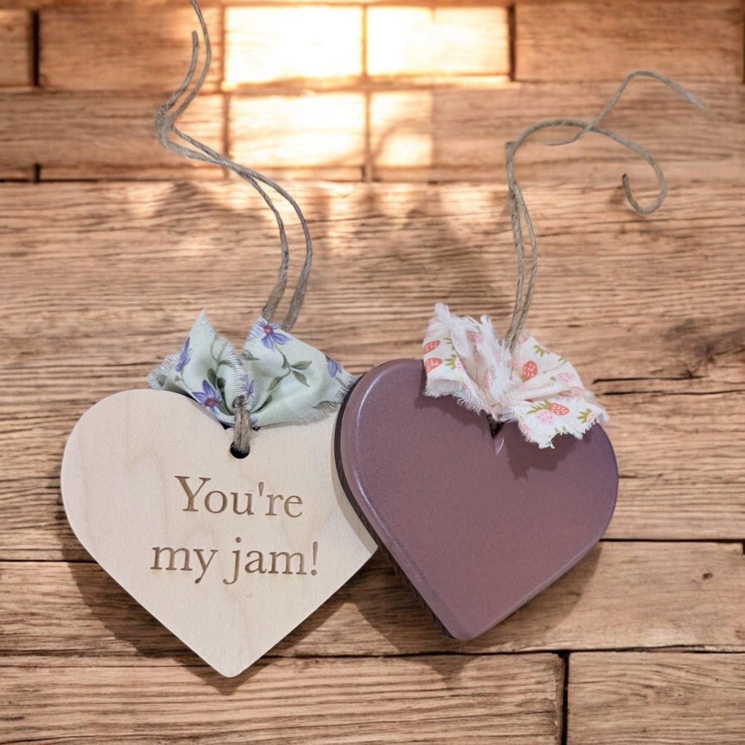 Heart-shaped wooden tags with floral strings on a wooden surface